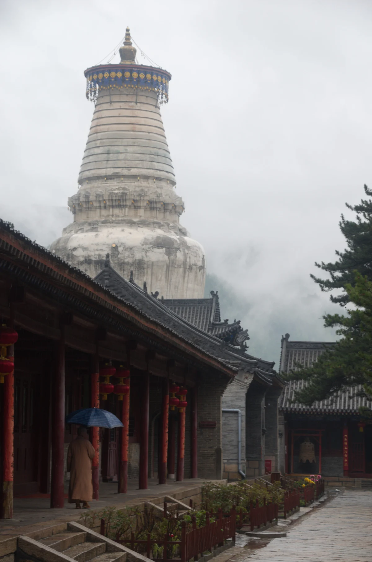White stupa and monk at Tayuan Temple on Mount Wutai
